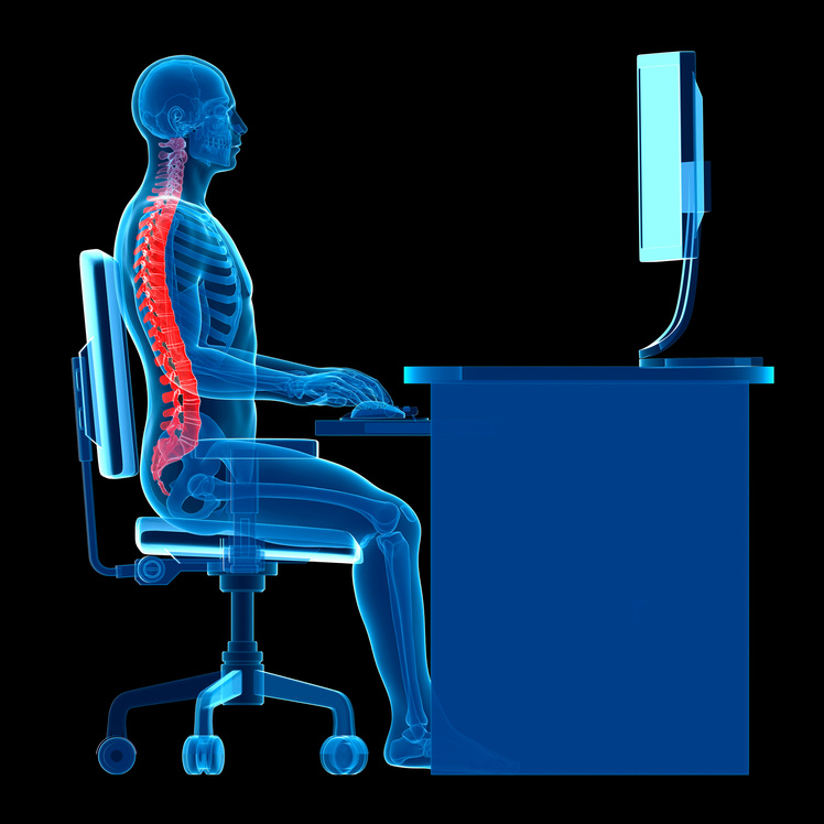 "Person using a computer sitting at a desk with the correct posture